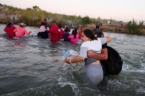 Migrants cross the Rio Grande river from Mexico into the United States.